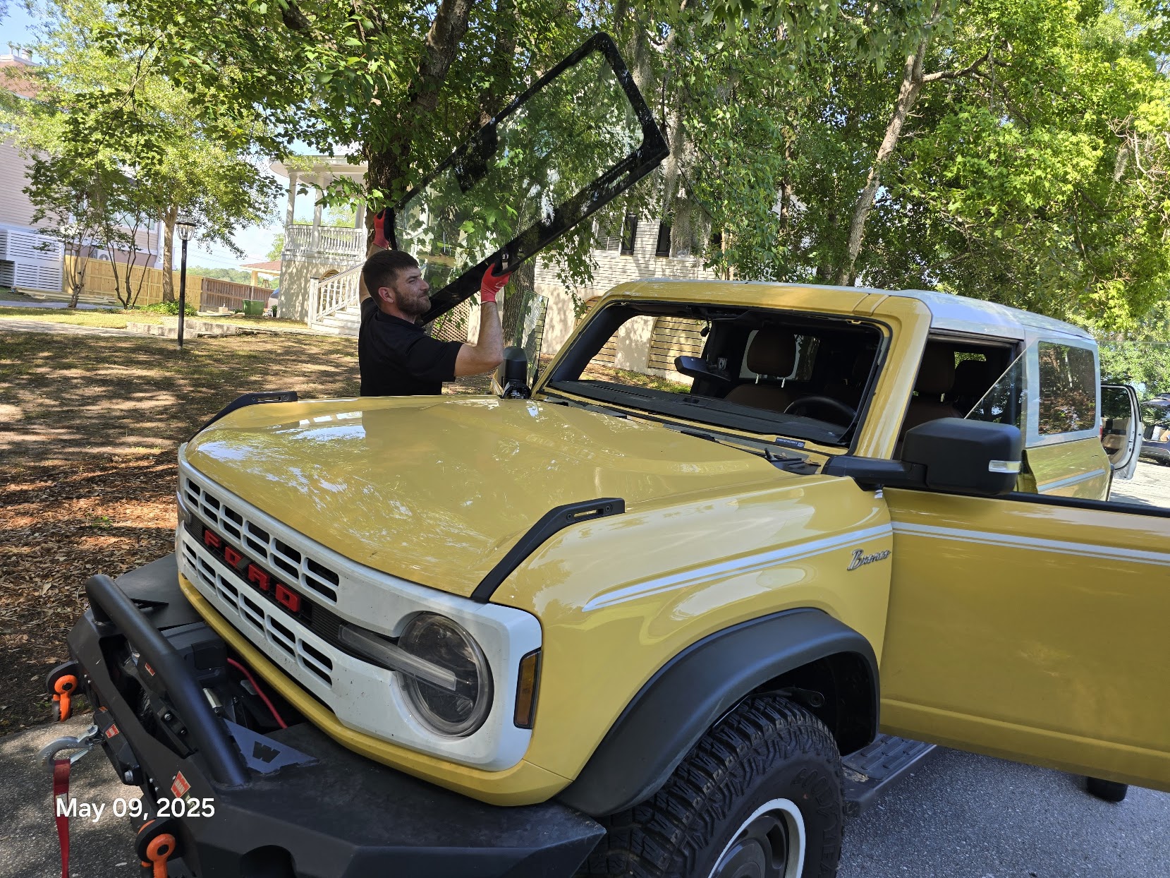 Mission Auto Glass technician installing windshield on Ford Bronco in Charleston SC neighborhood